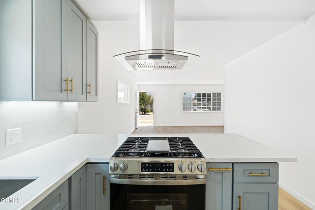 341 1st St, Fillmore, CA 93015 - kitchen with stainless steel gas range, gray cabinets, island range hood, a peninsula, and light stone counters