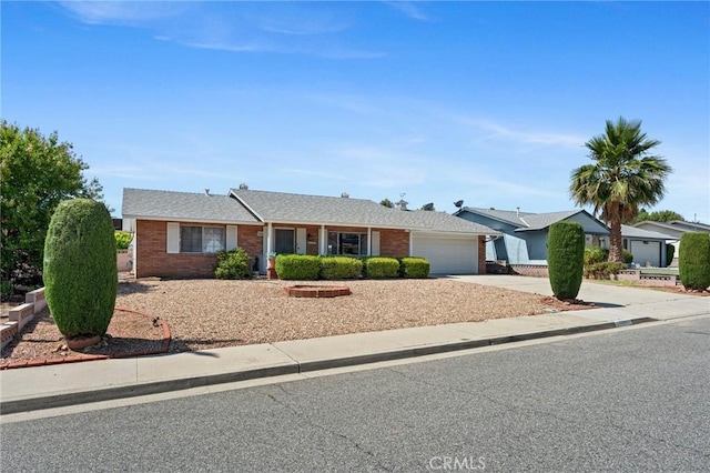25869 Sandy Lodge Rd, Menifee, CA 92586 - ranch-style house featuring an attached garage, driveway, and brick siding