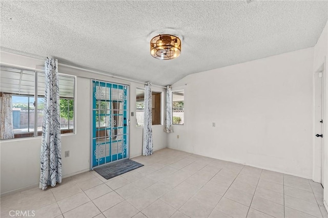 25869 Sandy Lodge Rd, Menifee, CA 92586 - entrance foyer featuring lofted ceiling, tile patterned floors, and a textured ceiling