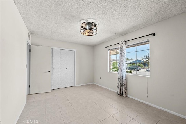 25869 Sandy Lodge Rd, Menifee, CA 92586 - unfurnished bedroom featuring a textured ceiling, a closet, and light tile patterned floors