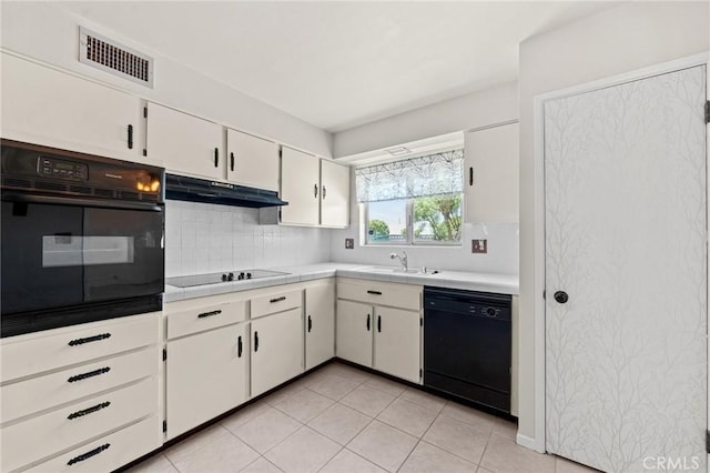 25869 Sandy Lodge Rd, Menifee, CA 92586 - kitchen with black appliances, under cabinet range hood, light countertops, backsplash, and white cabinetry