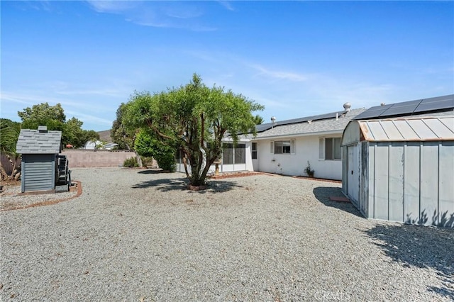 25869 Sandy Lodge Rd, Menifee, CA 92586 - rear view of house with roof mounted solar panels and a storage unit