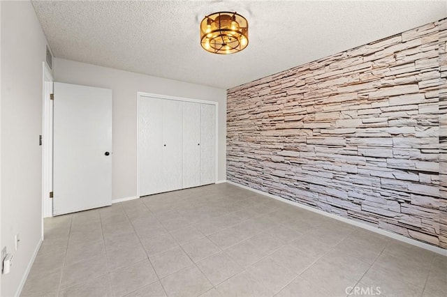 25869 Sandy Lodge Rd, Menifee, CA 92586 - unfurnished bedroom featuring a textured ceiling, a closet, and tile patterned flooring