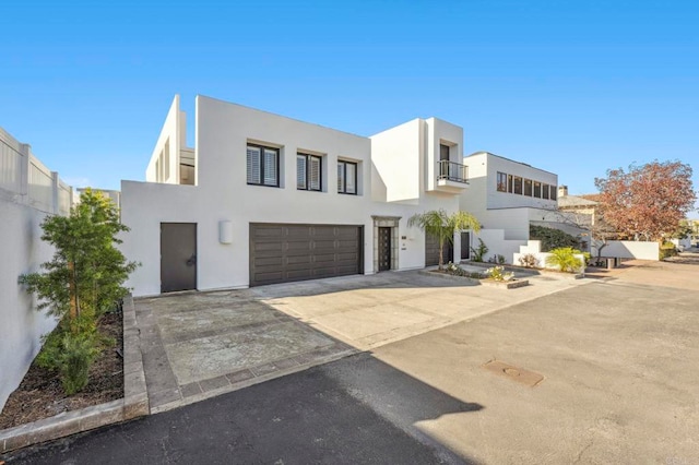 1716 Ocean Front, Del Mar, CA 92014 - modern home with an attached garage, a balcony, driveway, and stucco siding