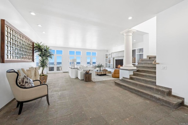 1716 Ocean Front, Del Mar, CA 92014 - living room with recessed lighting, ornate columns, a warm lit fireplace, and stairway