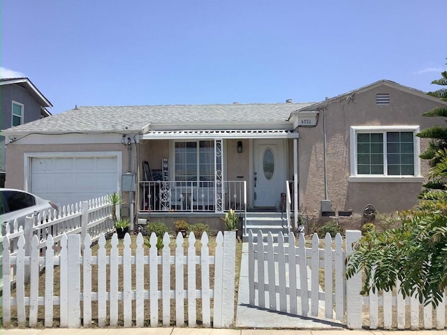 476870 Castle Ave, San Diego, CA 92105 - view of front of property with stucco siding, a garage, a fenced front yard, and driveway