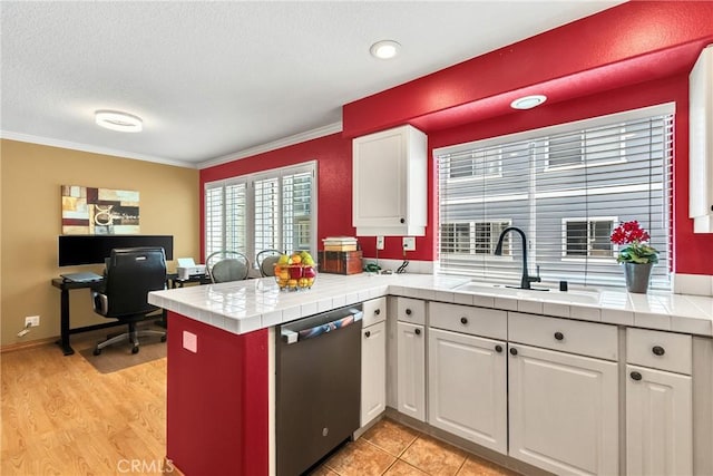 565 N Pageant Dr Unit B, Orange, CA 92869 - kitchen featuring dishwasher, white cabinetry, a peninsula, tile countertops, and ornamental molding