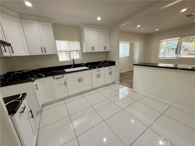 236 S 5th St, Montebello, CA 90640 - kitchen featuring dark countertops, white cabinetry, recessed lighting, and light tile patterned floors