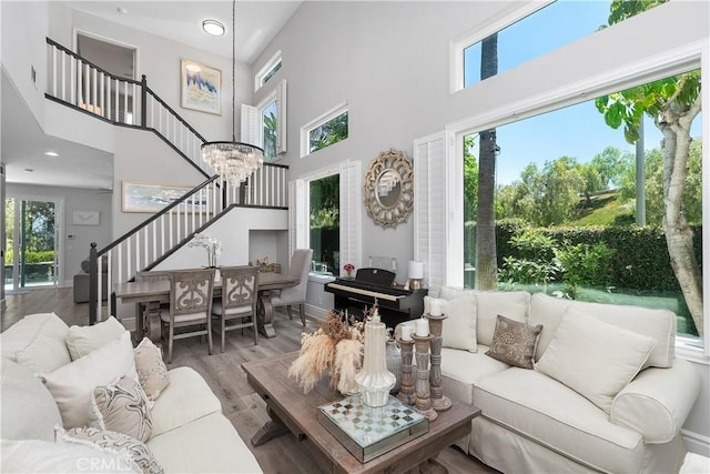 34 Key Largo, Aliso Viejo, CA 92656 - living area featuring stairway, a high ceiling, plenty of natural light, wood finished floors, and a chandelier