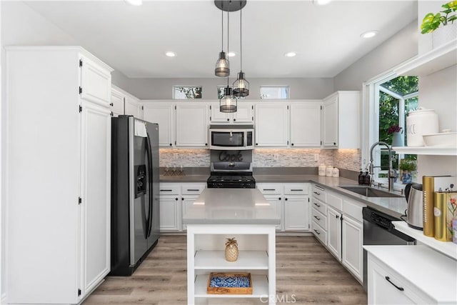 34 Key Largo, Aliso Viejo, CA 92656 - kitchen featuring appliances with stainless steel finishes, open shelves, white cabinets, decorative backsplash, and recessed lighting