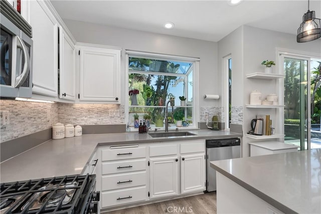 34 Key Largo, Aliso Viejo, CA 92656 - kitchen featuring appliances with stainless steel finishes, plenty of natural light, white cabinets, tasteful backsplash, and recessed lighting