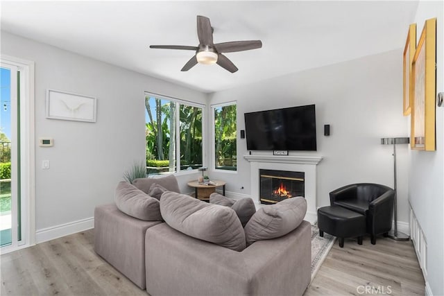 34 Key Largo, Aliso Viejo, CA 92656 - living area featuring a glass covered fireplace, light wood finished floors, and ceiling fan