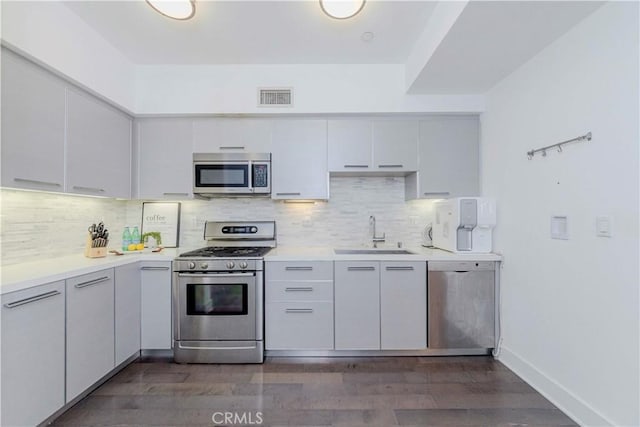 1817 Prosser Ave Unit 305, Los Angeles, CA 90025 - kitchen with appliances with stainless steel finishes, dark wood-style floors, light countertops, and backsplash