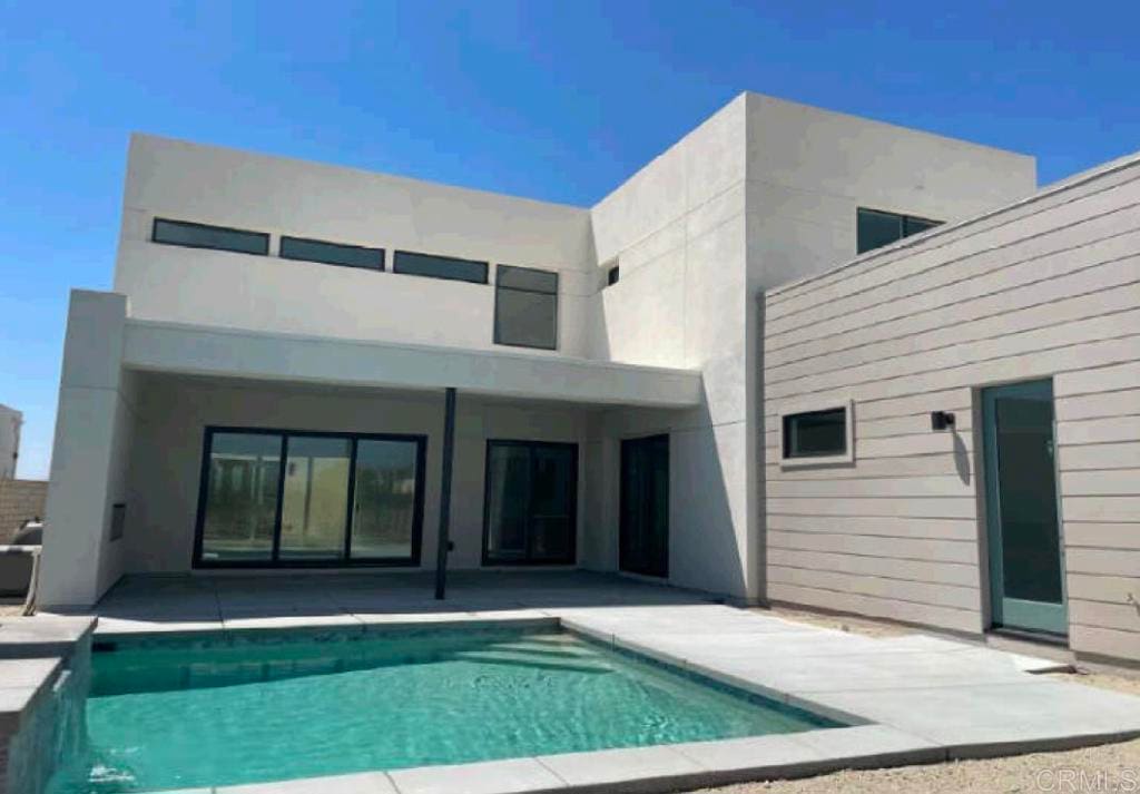 455 Palladium Blvd, Palm Springs, CA 92262 - back of property with a patio, an outdoor pool, and stucco siding