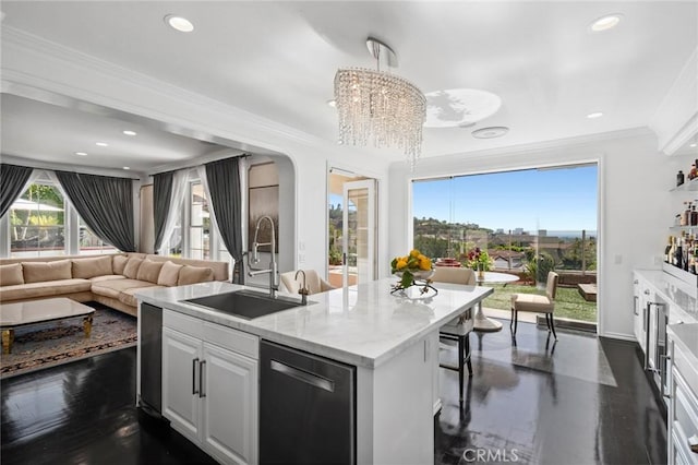 17 Lemans, Newport Coast, CA 92657 - kitchen featuring dishwashing machine, recessed lighting, a center island with sink, ornamental molding, and arched walkways