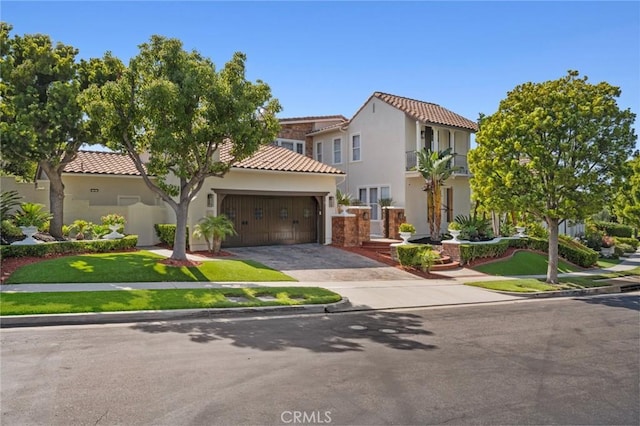17 Lemans, Newport Coast, CA 92657 - mediterranean / spanish-style house featuring a tiled roof, a garage, driveway, and stucco siding