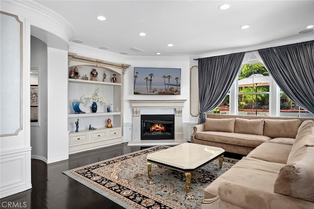 17 Lemans, Newport Coast, CA 92657 - living area with crown molding, a glass covered fireplace, dark wood-style floors, recessed lighting, and built in shelves