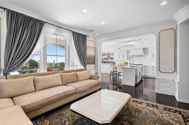 17 Lemans, Newport Coast, CA 92657 - living area with dark wood-style floors, ornamental molding, recessed lighting, and arched walkways