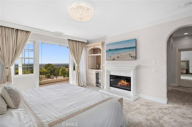 17 Lemans, Newport Coast, CA 92657 - carpeted bedroom featuring ornamental molding, arched walkways, and a glass covered fireplace
