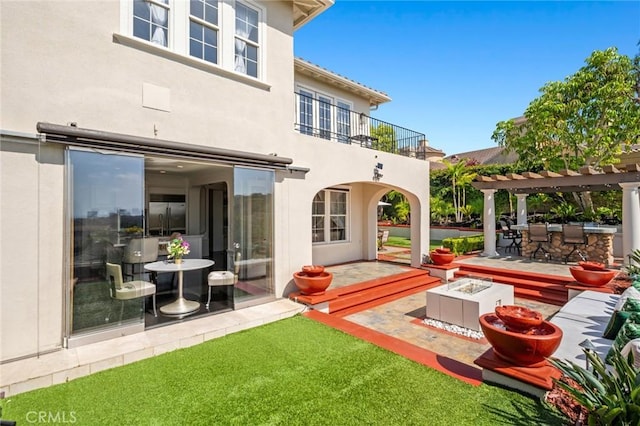 17 Lemans, Newport Coast, CA 92657 - back of house featuring a balcony, stucco siding, a patio, and a pergola