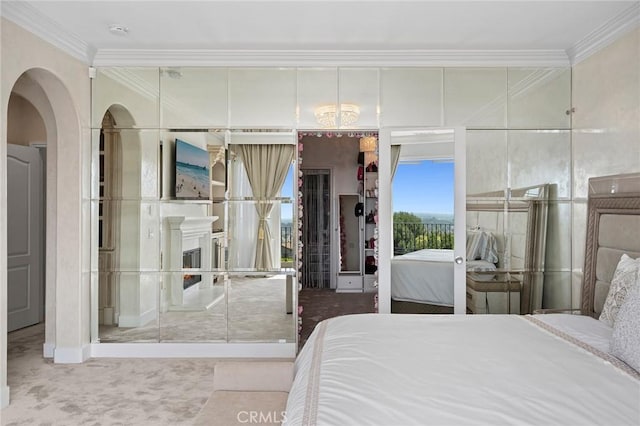 17 Lemans, Newport Coast, CA 92657 - bedroom featuring ornamental molding, carpet, arched walkways, and a fireplace