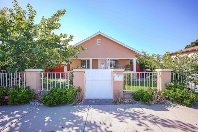 320 W 8th Ave, Escondido, CA 92025 - view of front of home featuring stucco siding, a fenced front yard, and a gate