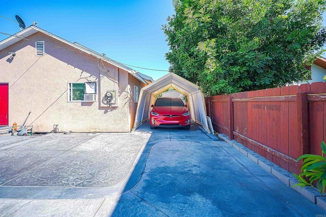 320 W 8th Ave, Escondido, CA 92025 - view of side of home with a carport, stucco siding, and concrete driveway