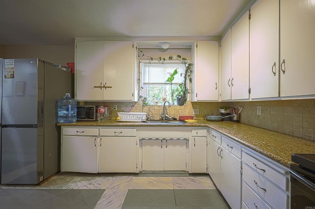 320 W 8th Ave, Escondido, CA 92025 - kitchen with stainless steel appliances, decorative backsplash, and white cabinets