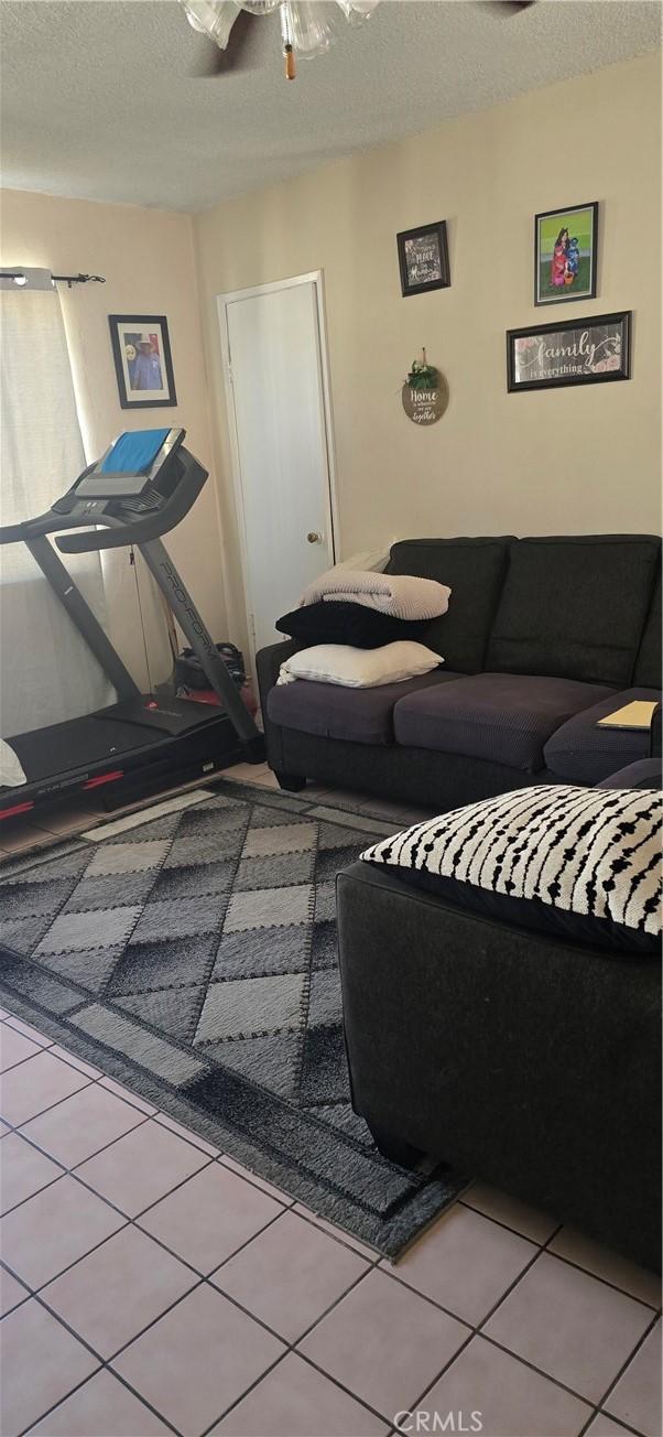 717 W 54th St, Los Angeles, CA 90037 - living room with a textured ceiling and tile patterned floors