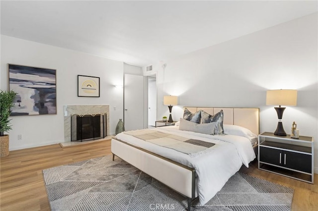 1277 S Beverly Glen Blvd Unit 205, Los Angeles, CA 90024 - bedroom featuring wood finished floors and a high end fireplace