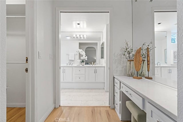 1277 S Beverly Glen Blvd Unit 205, Los Angeles, CA 90024 - full bath featuring double vanity and wood finished floors