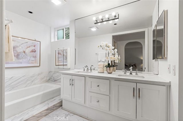 1277 S Beverly Glen Blvd Unit 205, Los Angeles, CA 90024 - bathroom featuring double vanity, a garden tub, and marble look tiles