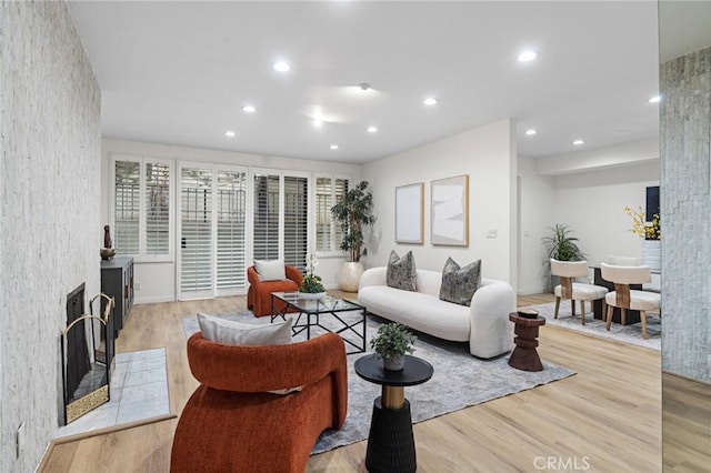 1277 S Beverly Glen Blvd Unit 205, Los Angeles, CA 90024 - living area featuring light wood-style flooring, a large fireplace, and recessed lighting