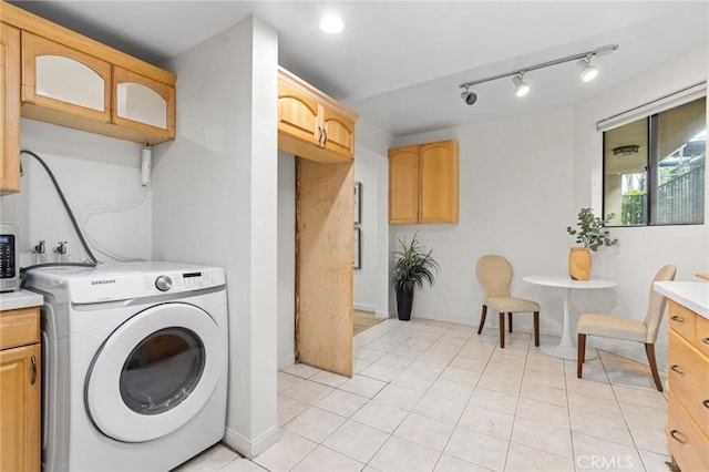 1277 S Beverly Glen Blvd Unit 205, Los Angeles, CA 90024 - laundry area with washer / dryer and light tile patterned floors