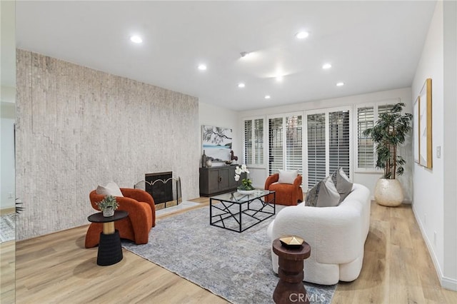 1277 S Beverly Glen Blvd Unit 205, Los Angeles, CA 90024 - living room featuring an accent wall, recessed lighting, and wood finished floors