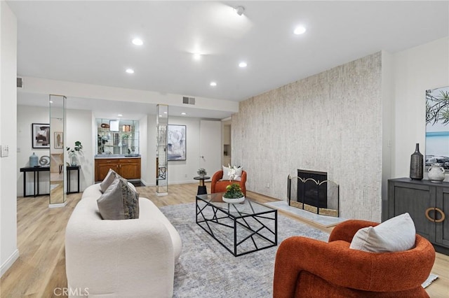 1277 S Beverly Glen Blvd Unit 205, Los Angeles, CA 90024 - living area featuring light wood-style flooring, recessed lighting, an accent wall, a fireplace, and wallpapered walls