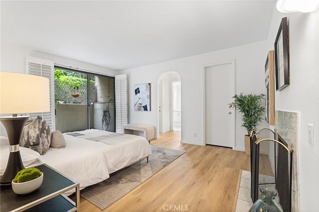 1277 S Beverly Glen Blvd Unit 205, Los Angeles, CA 90024 - bedroom featuring arched walkways and light wood-style floors