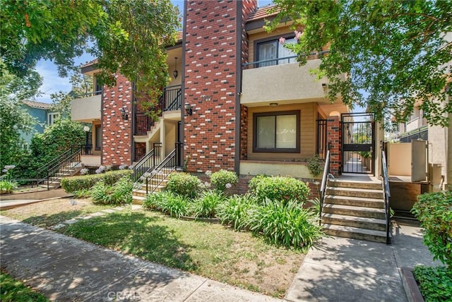1207 N Columbus Ave, Glendale, CA 91202 - multi unit property featuring a gate, a chimney, stucco siding, brick siding, and stairway
