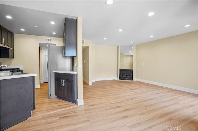 1207 N Columbus Ave, Glendale, CA 91202 - kitchen featuring light countertops, light wood-style flooring, under cabinet range hood, recessed lighting, and open floor plan