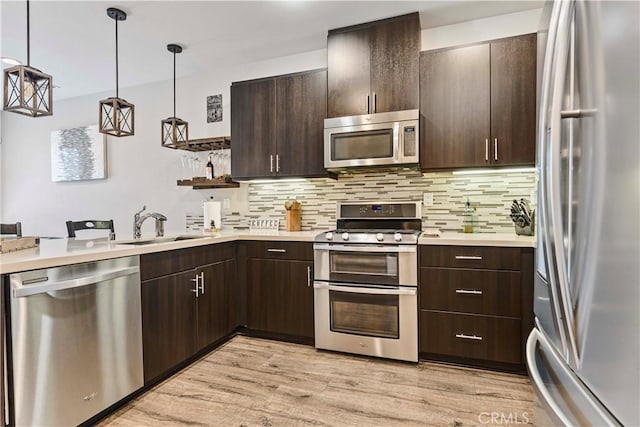 6 Fenix St, Rancho Mission Viejo, CA 92694 - kitchen with stainless steel appliances, light countertops, dark brown cabinets, and light wood-type flooring