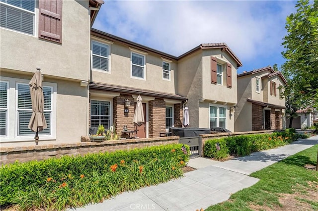 6 Fenix St, Rancho Mission Viejo, CA 92694 - view of front of home with stucco siding, a fenced front yard, and a gate