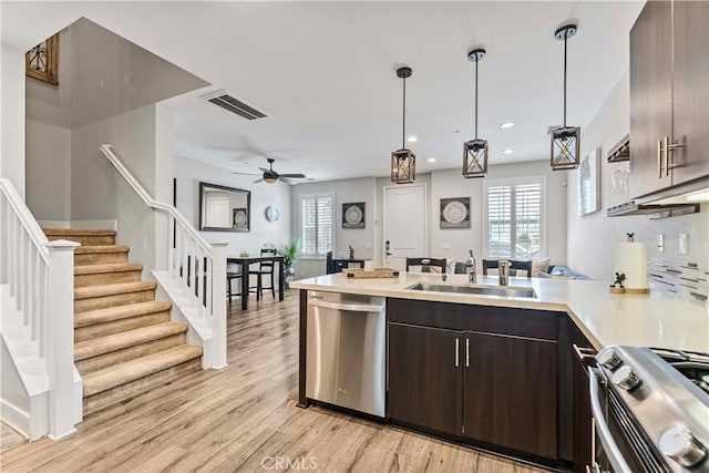 6 Fenix St, Rancho Mission Viejo, CA 92694 - kitchen featuring appliances with stainless steel finishes, a peninsula, dark brown cabinetry, light countertops, and light wood-style floors