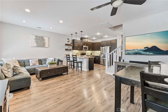 6 Fenix St, Rancho Mission Viejo, CA 92694 - living room featuring a ceiling fan, recessed lighting, light wood-style flooring, and stairs