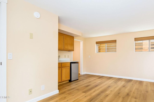381 Highland Dr, Oxnard, CA 93035 - kitchen with light wood-style floors, brown cabinets, light countertops, and dishwasher
