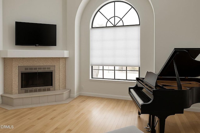 381 Highland Dr, Oxnard, CA 93035 - living area featuring wood finished floors, arched walkways, and a tiled fireplace