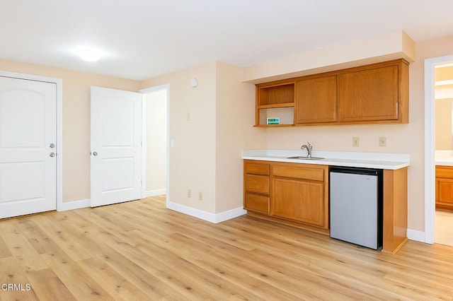 381 Highland Dr, Oxnard, CA 93035 - kitchen with open shelves, light wood finished floors, and brown cabinets