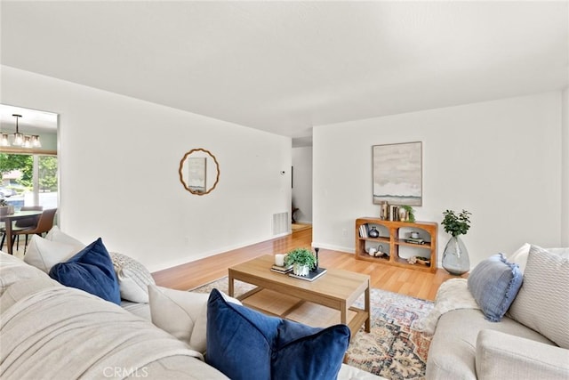 667 Morgan Dr, Chico, CA 95973 - living room with wood finished floors and a chandelier
