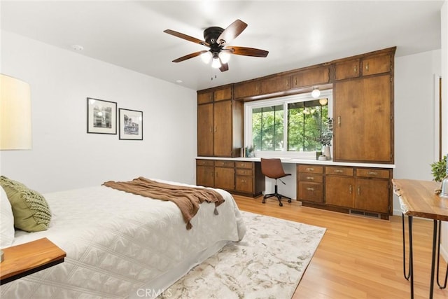 667 Morgan Dr, Chico, CA 95973 - bedroom featuring light wood-style floors, built in study area, and a ceiling fan