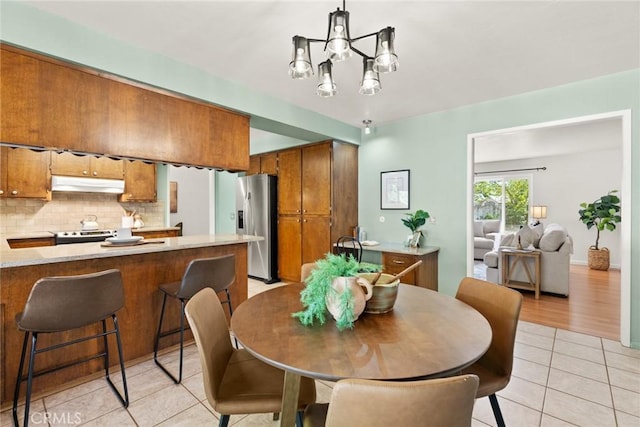 667 Morgan Dr, Chico, CA 95973 - dining room with light tile patterned floors and a chandelier