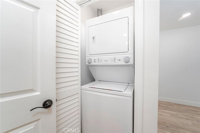 2143 Ronda Granada Unit P, Laguna Woods, CA 92637 - laundry room featuring stacked washer / dryer and light wood-style floors